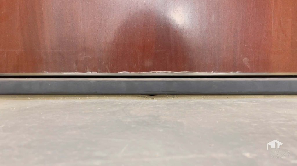 adjusting the draught excluder on an armoured door